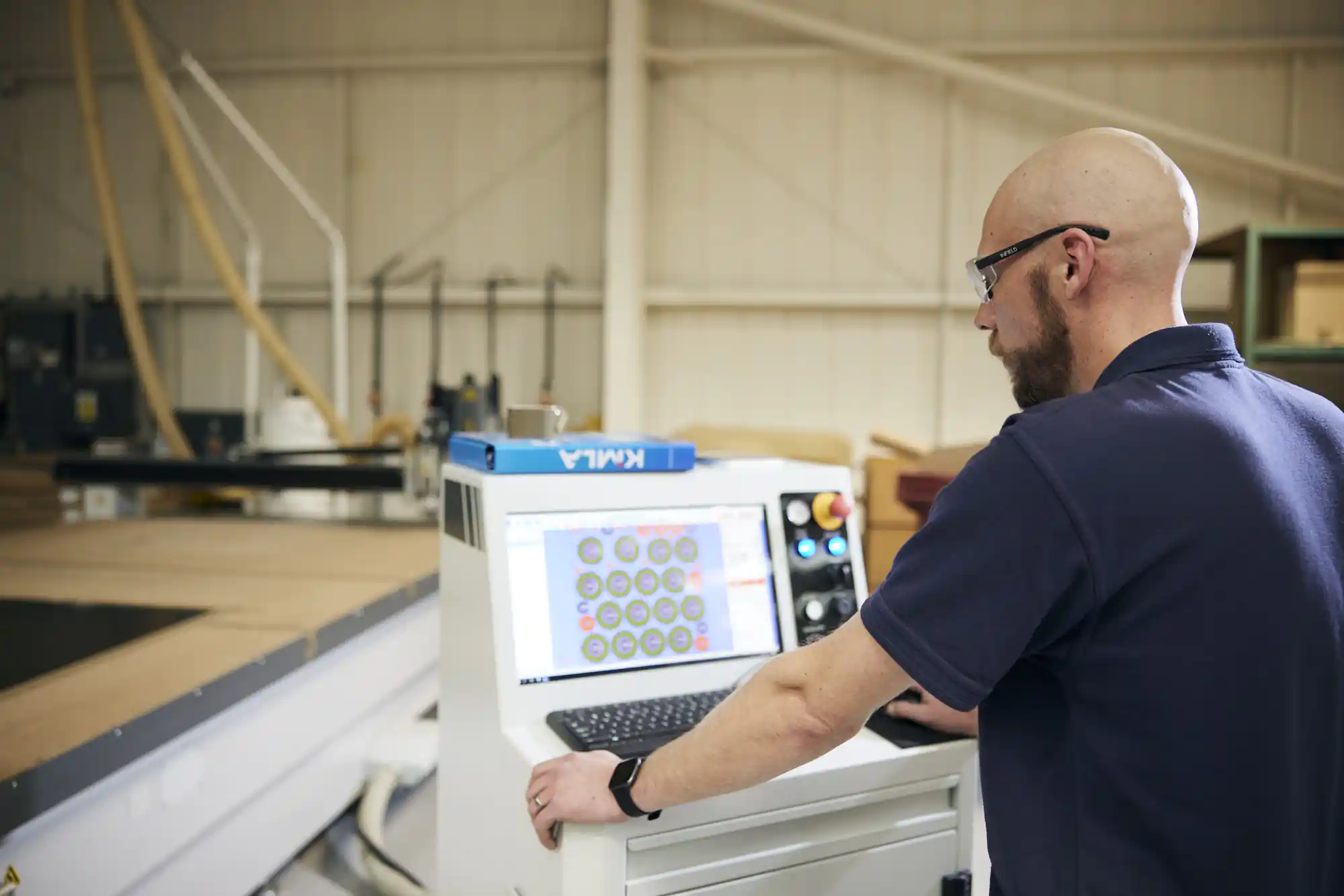 man working on precision cutting materials