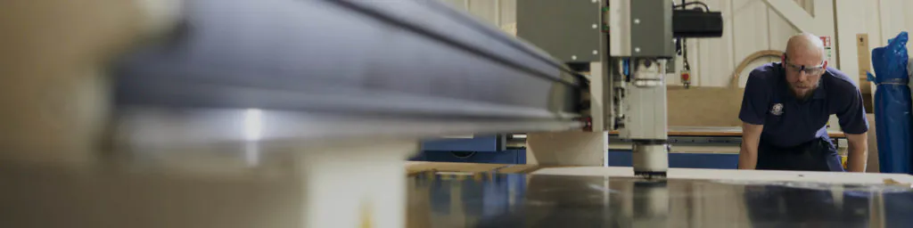 man working on a precision services machine